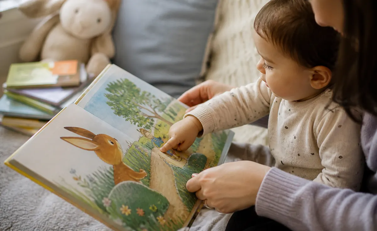 Parent and toddler reading a gentle story together